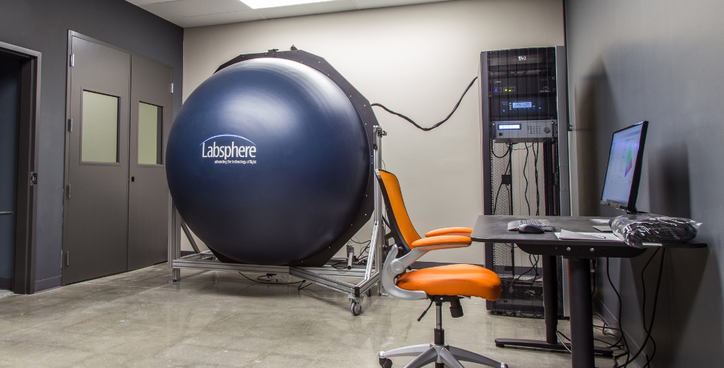 Testing lab showing labsphere and desk with preview of photometric report