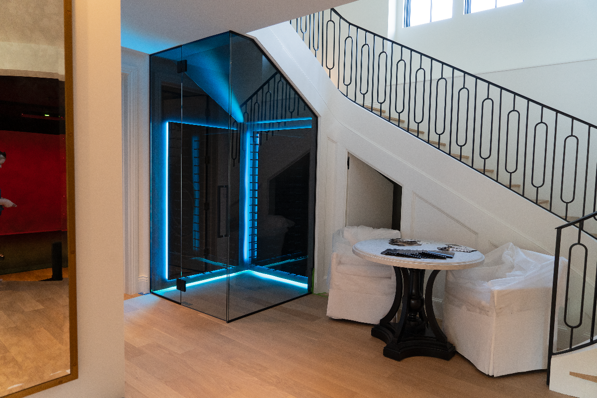 Wine rack under stairs with blue strip lighting in the wine rack