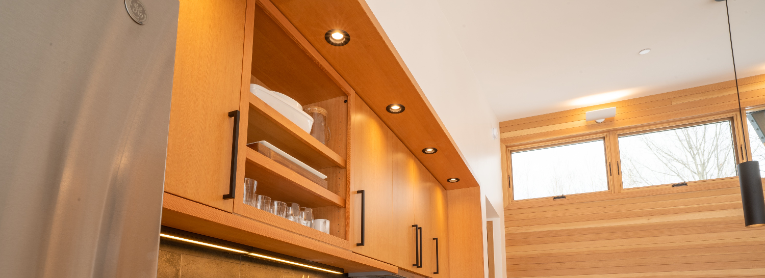 Wooden cabinets with shelves and a window in a kitchen setting