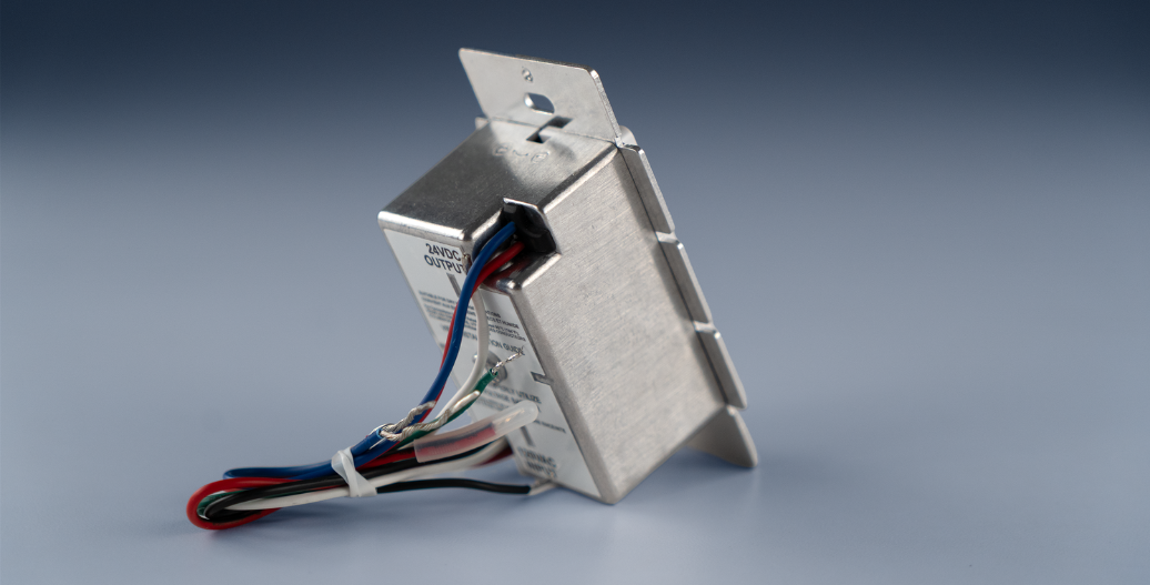 Wiring on the back of the Single Color InDrive 2-in-1 Dimmer Switch + Driver with a blue background