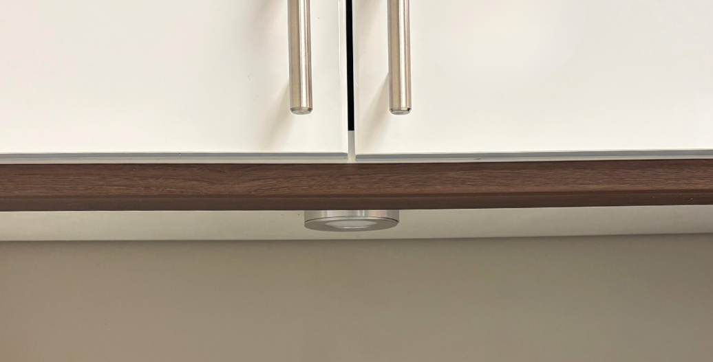 Puck light under white cabinets 
