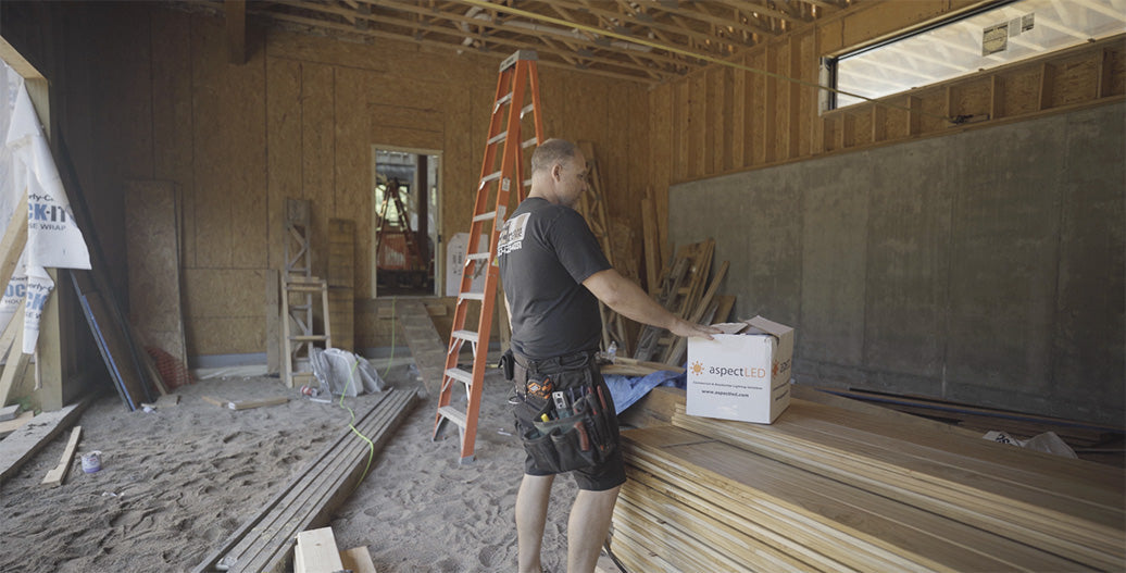 Electrician opening aspectLED box on job site