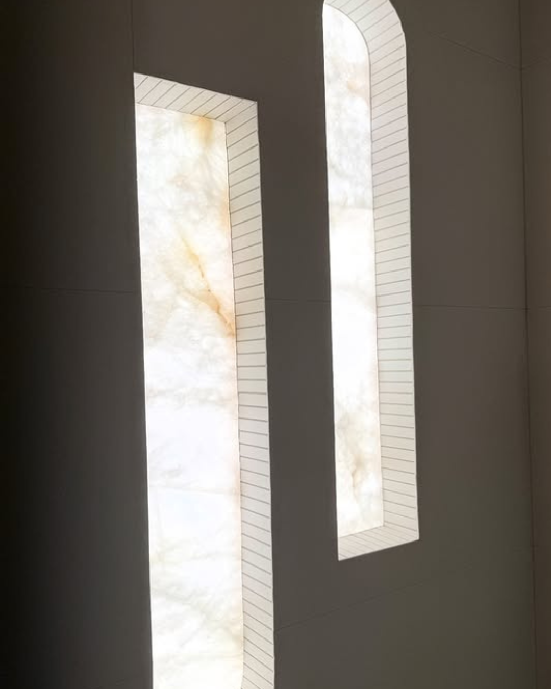Two rectangular stones backlit by light sheets on a dark wall
