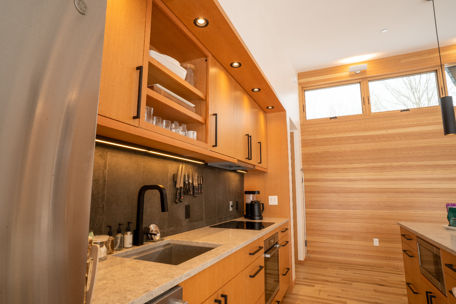Modern kitchen with wooden cabinets and stainless steel appliances