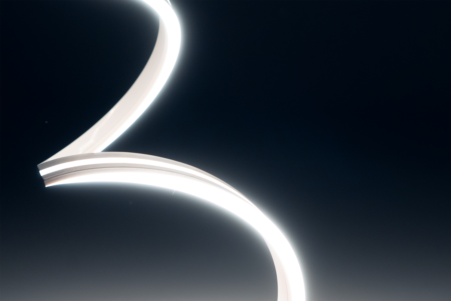 Curved LED light strip on a dark background