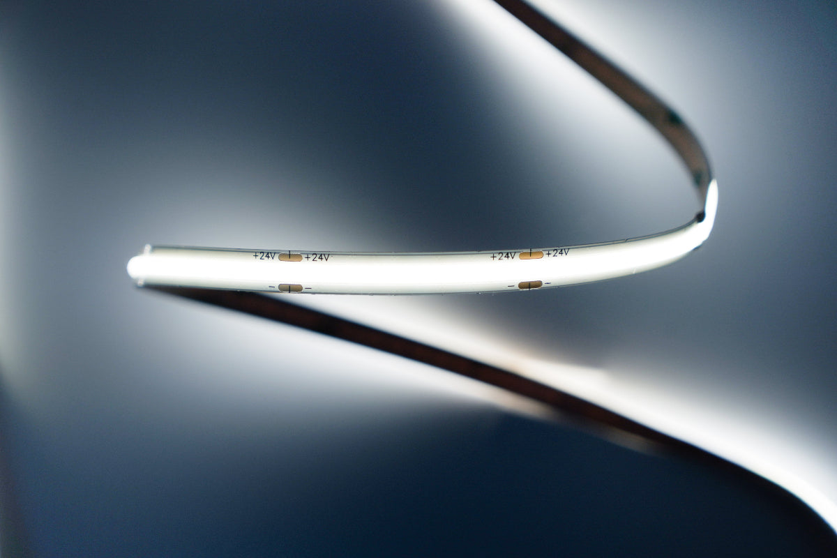 Close-up of a LED strip Light on a reflective surface with a blurred background