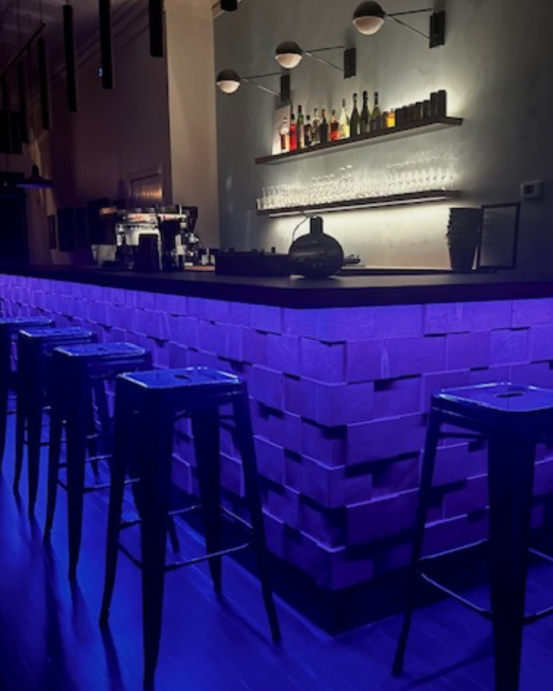 Lighting under bar with stools 
